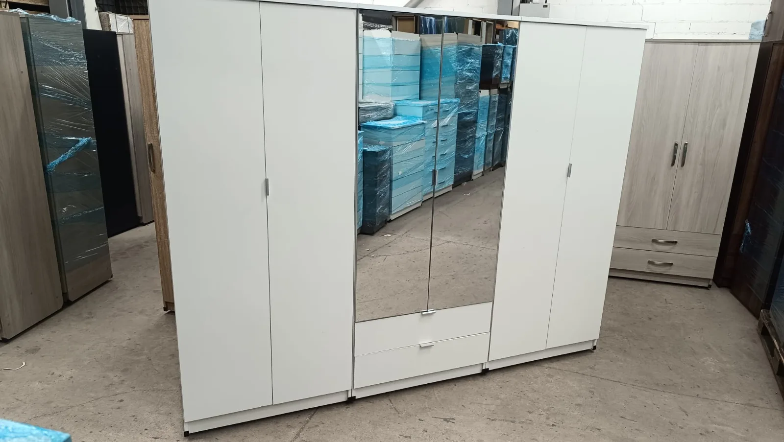 Three-door wardrobe finished in warm oak